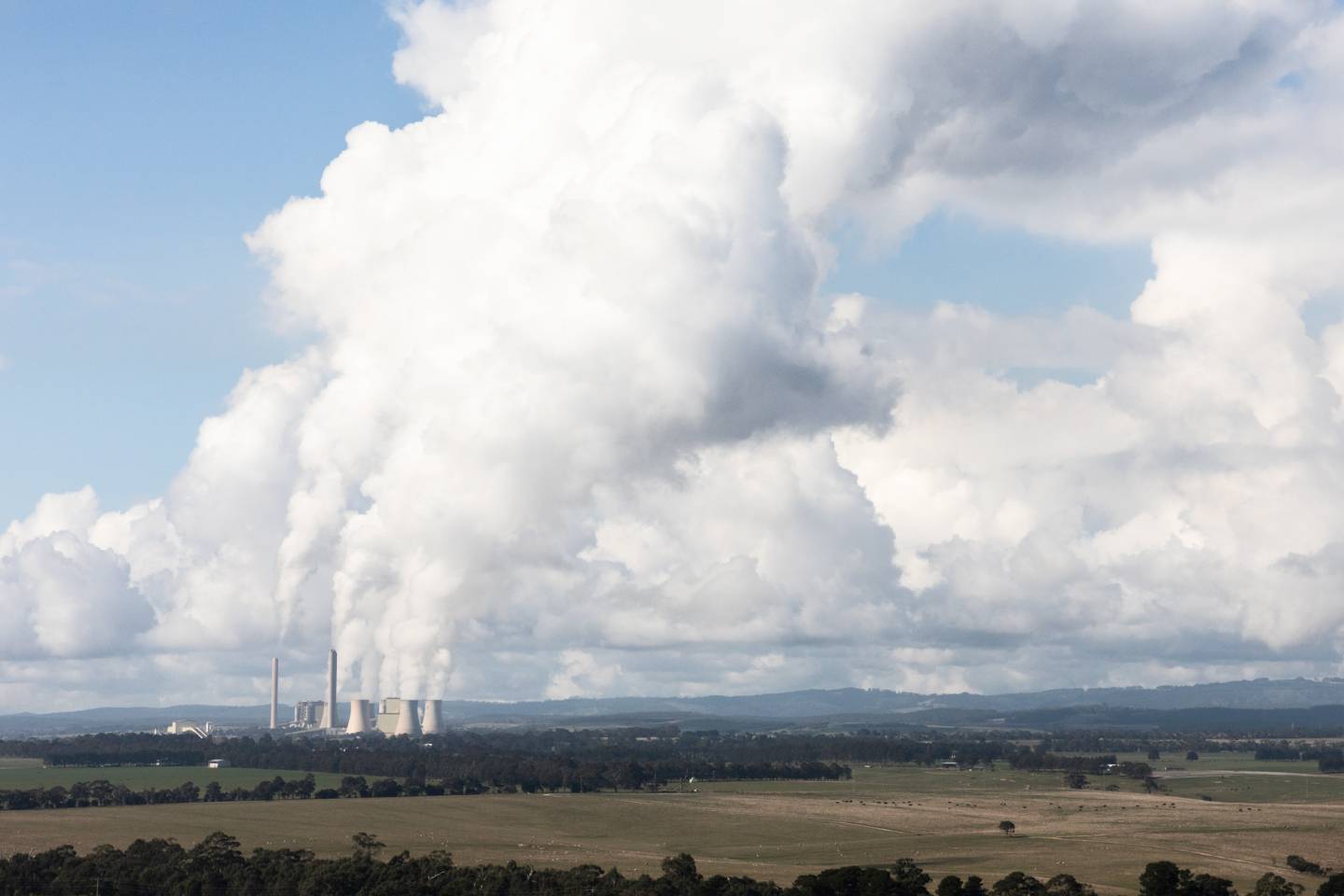 Emissions into the sky from a power plant on the horizon